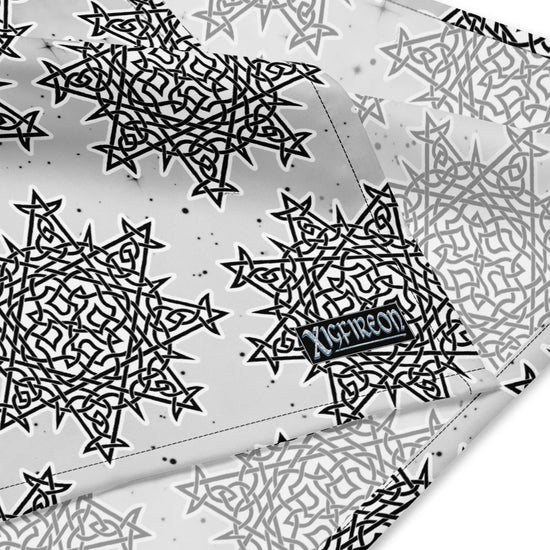 A close up view of the Xigfireon logo on a large sized (25.25 inch x 25.25 inch) Morning Star Fire Black and White Solid Cosmos Inverted bandana.