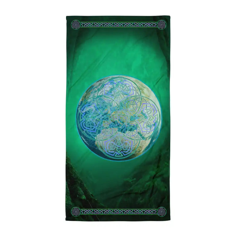 A Xigfireon bath and beach towel featuring the Deep Forest iteration of the Reach Of The Spirit Celtic knot design displayed within a lush green woodland landscape.