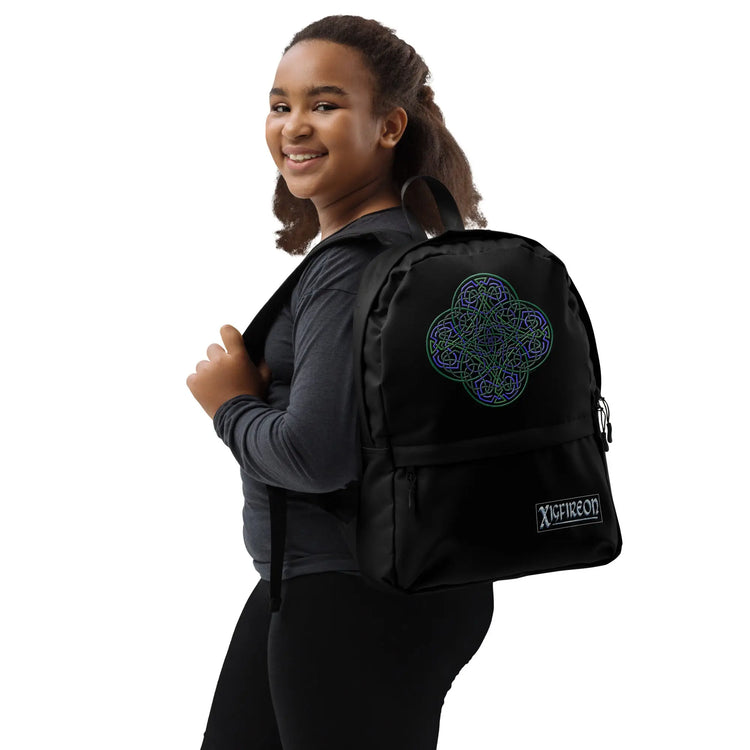 A student wearing a Xigfireon graphic backpack featuring the Living Colour iteration of the `Reach Of The Spirit` Celtic knot design. The `Reach Of The Spirit` Celtic knot symbolizes Mother Earth.