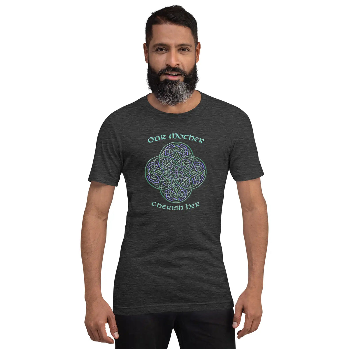 A young man wearing a dark grey heather graphic t-shirt featuring the Living Colour iteration of the Reach Of The Spirit Celtic knot design along with a message in a Celtic font: "Our Mother, Cherish Her".
