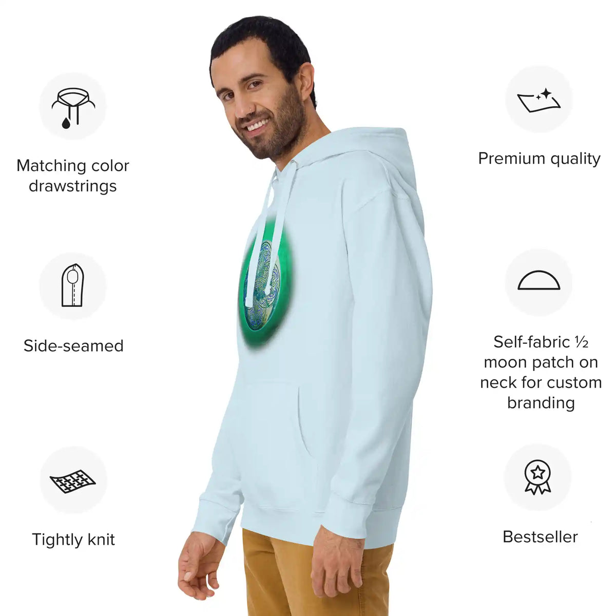 A young man wearing a sky blue Xigfireon graphic hoodie featuring the Deep Forest iteration of the Reach Of The Spirit Celtic knot design. Product specs surround him, reading: Matching color drawstrings, side-seamed, tightly knit, premium qualtiy, self-fabric 1/2 moon patch on neck for custom branding, bestseller.