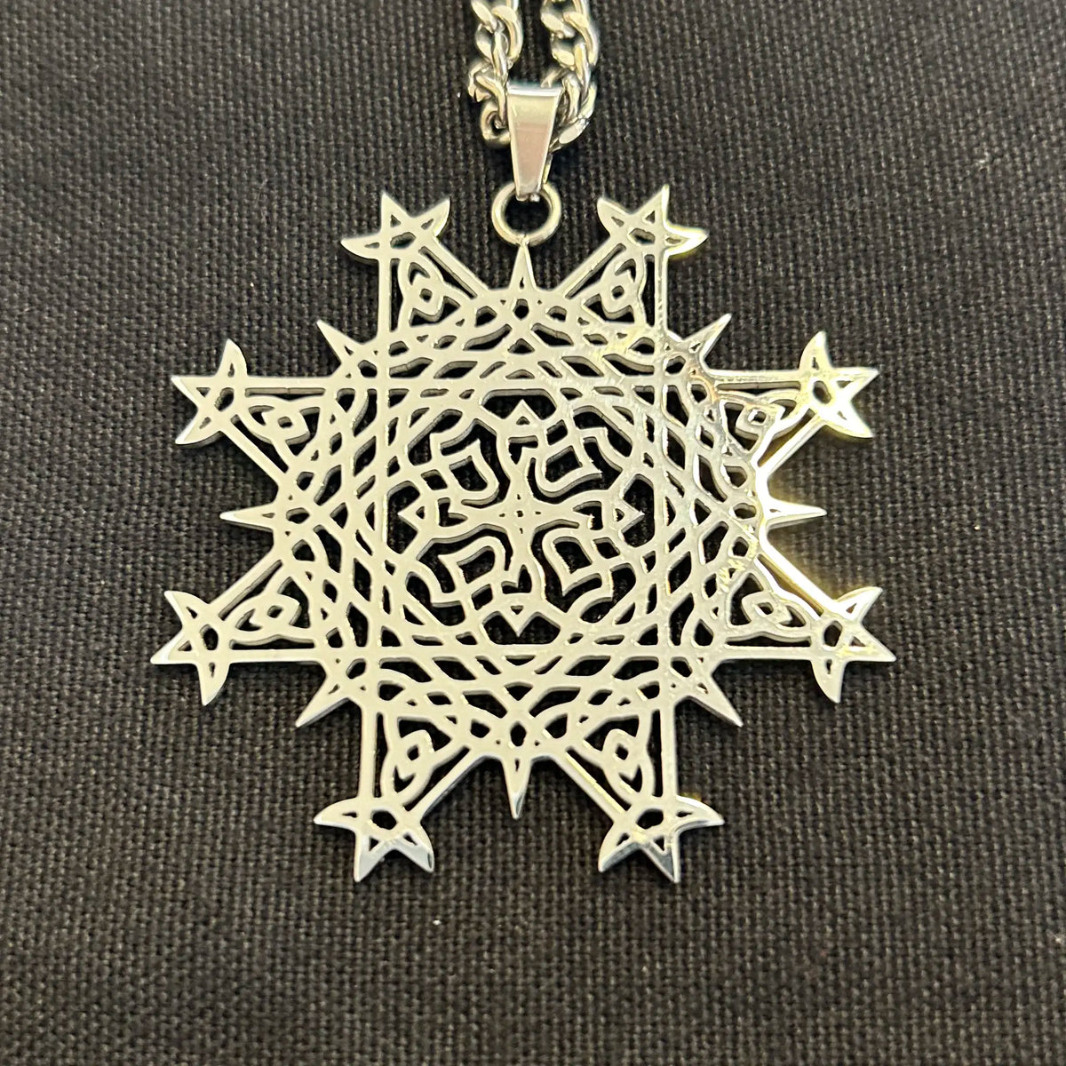 Necklace, up close, with a Morning Star Fire Celtic knot pendant in flat stainless steel by Xigfireon.