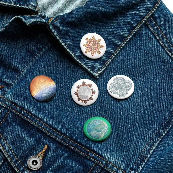 A jean jacket with 5 assorted 1.25 inch pin-back buttons featuring Morning Star Fire, Reach Of The Spirit, and Derivation II Celtic knot designs.