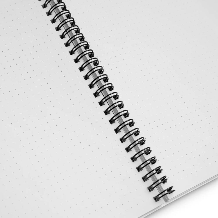 The inside pages, showing a dotted grid pattern, of a Xigfireon graphic spiral notebook featuring the Derivation II Celtic knots merger design.