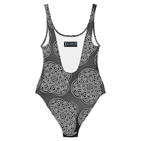 The back side of a Xigfireon graphic swimsuit featuring the Black & White Solid Forest patterned series of the Reach Of The Spirit Celtic knot design.