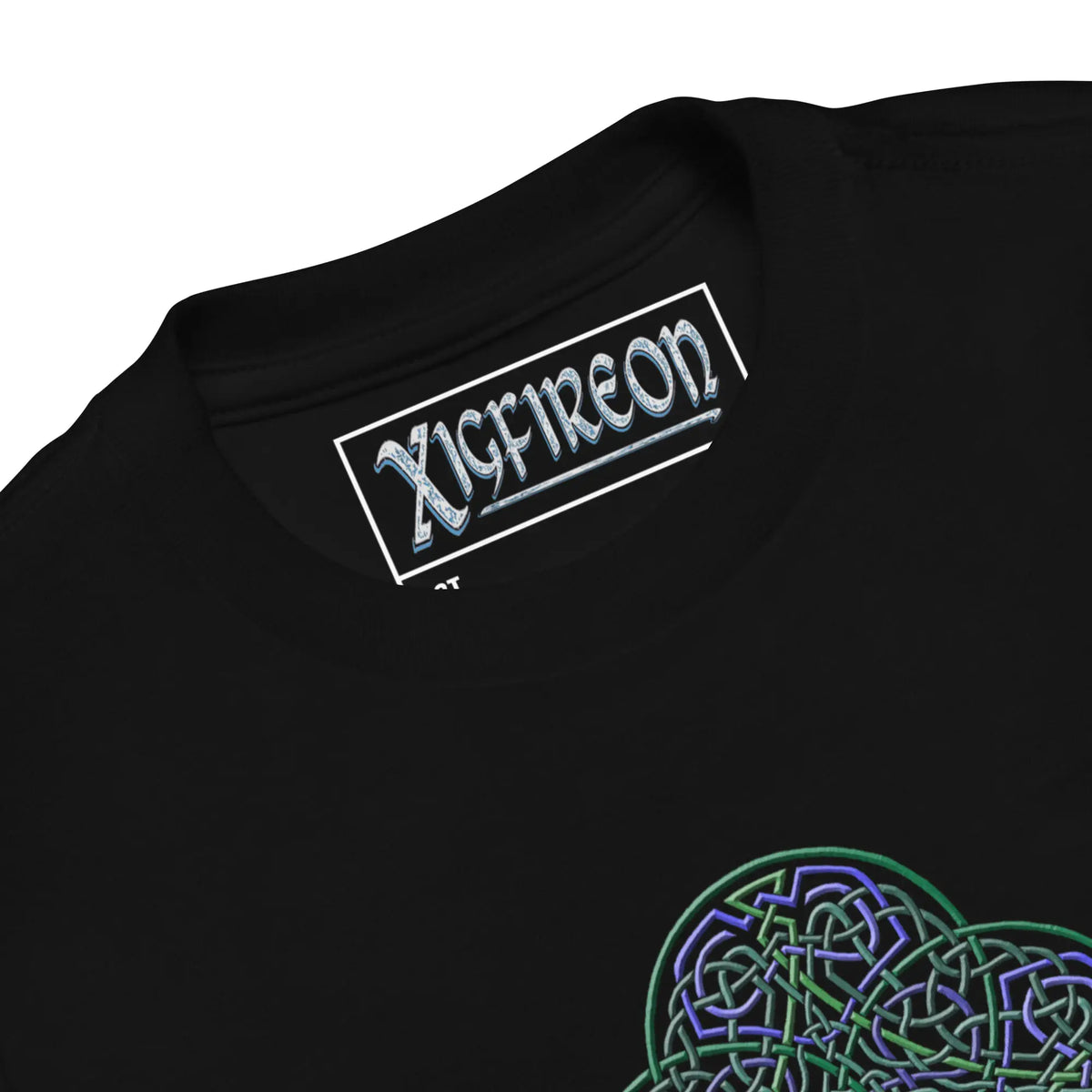 A close-up view of the logo and design on a black Xigfireon toddler graphic t-shirt featuring the Living Colour iteration of the Reach Of The Spirit Celtic knot design. The Reach Of The Spirit Celtic knot represents Mother Earth.