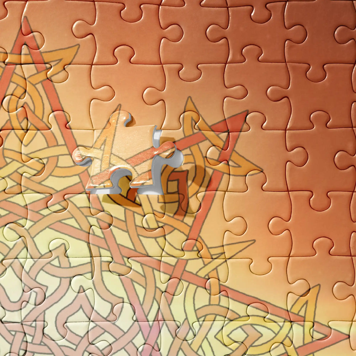 A close-up view of a 520 piece jigsaw puzzle featuring the Derivation II Celtic knot merger design, which symbolizes the Sun and the Earth and their cosmic dance.