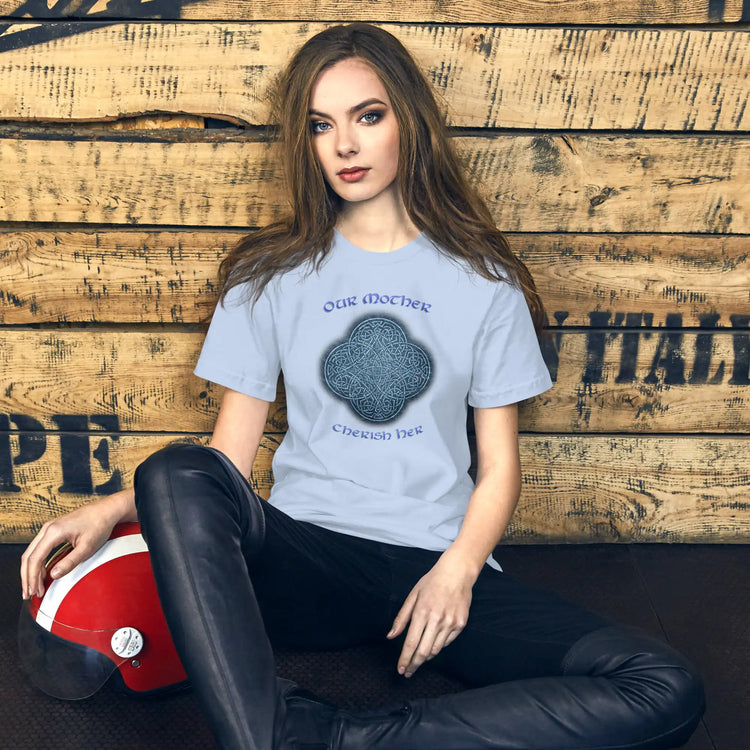 A young woman wearing a baby blue Xigfireon graphic t-shirt featuring the Blue Slate iteration of the `Reach Of The Spirit` Celtic knot design along with a message in a Celtic font: "Our Mother, Cherish Her".