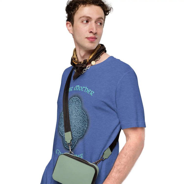 A young man wearing a heather true royal blue Xigfireon graphic tee featuring the Blue Slate iteration of the `Reach Of The Spirit` Celtic knot design along with a message in a Celtic font: "Our Mother, Cherish Her".