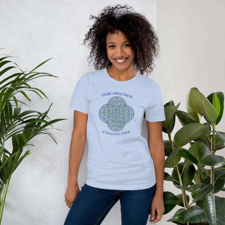 A young woman wearing a baby blue Xigfireon graphic t-shirt featuring the Living Colour iteration of the `Reach Of The Spirit` Celtic knot design along with a message in a Celtic font: "Our Mother, Cherish Her".