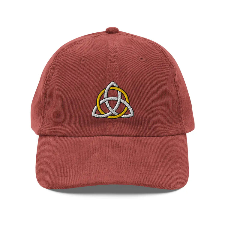 The front side of a burgundy Xigfireon vintage corduroy cap embroidered with a White & Gold Celtic Trinity Knot