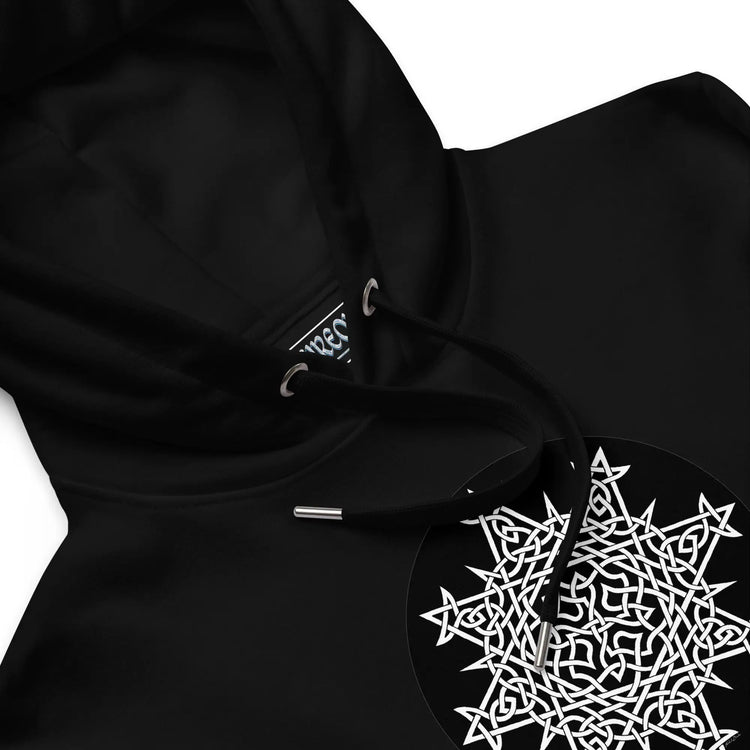 A close-up view of a black Xigfireon graphic eco hoodie featuring the Black & White Circle iteration of the `Morning Star Fire` Celtic knot design. The `Morning Star Fire` Celtic knot symbolizes the Sun.