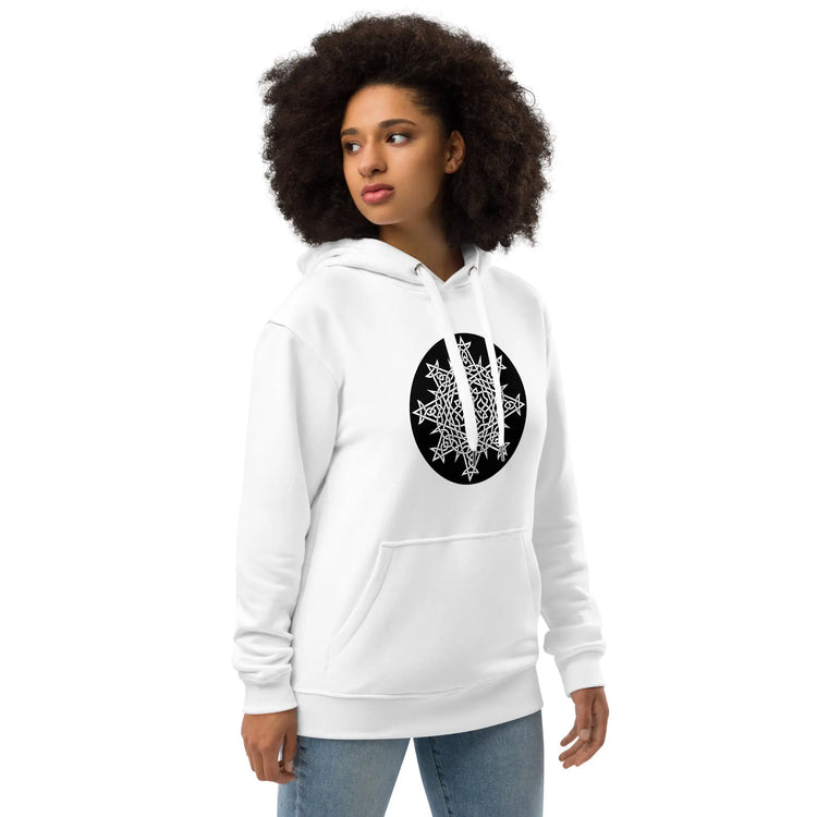 A young woman wearing a white Xigfireon graphic eco hoodie featuring the Black & White Circle iteration of the `Morning Star Fire` Celtic knot design. The `Morning Star Fire` Celtic knot symbolizes the Sun.