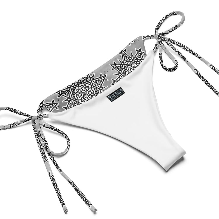 A view of the inside of a string bikini bottom featuring the Inverted Black & White Solid Cosmos iteration of the `Morning Star Fire` Celtic knot pattern.