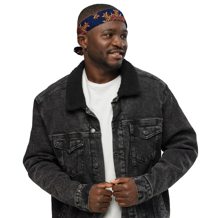 A young man wearing a Xigfireon bandana adorned with the `Morning Star Fire` Fire Colour Cosmos Celtic knot pattern.