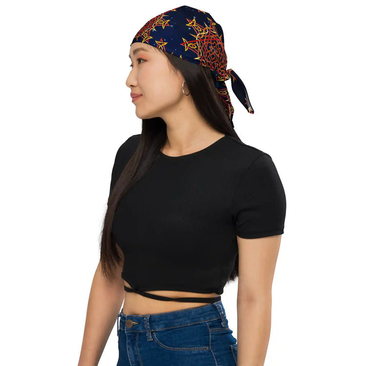 A young woman wearing a Xigfireon bandana adorned with the `Morning Star Fire` Fire Colour Cosmos Celtic knot pattern.