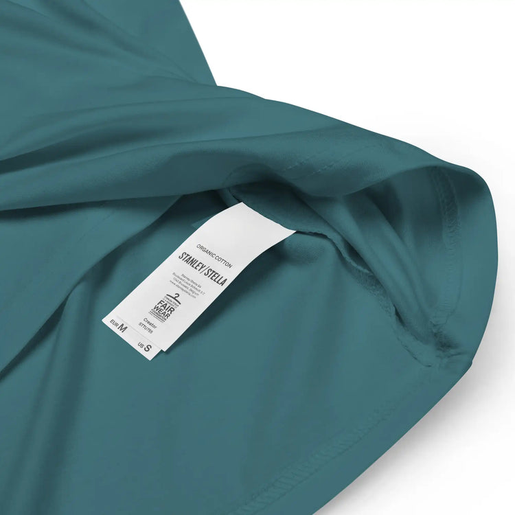A close-up view of a product tag on a stargazer Xigfireon graphic organic cotton t-shirt featuring the Fire Colour iteration of the `Morning Star Fire` Celtic knot design. The `Morning Star Fire` Celtic knot represents our benevolent Father Sun.