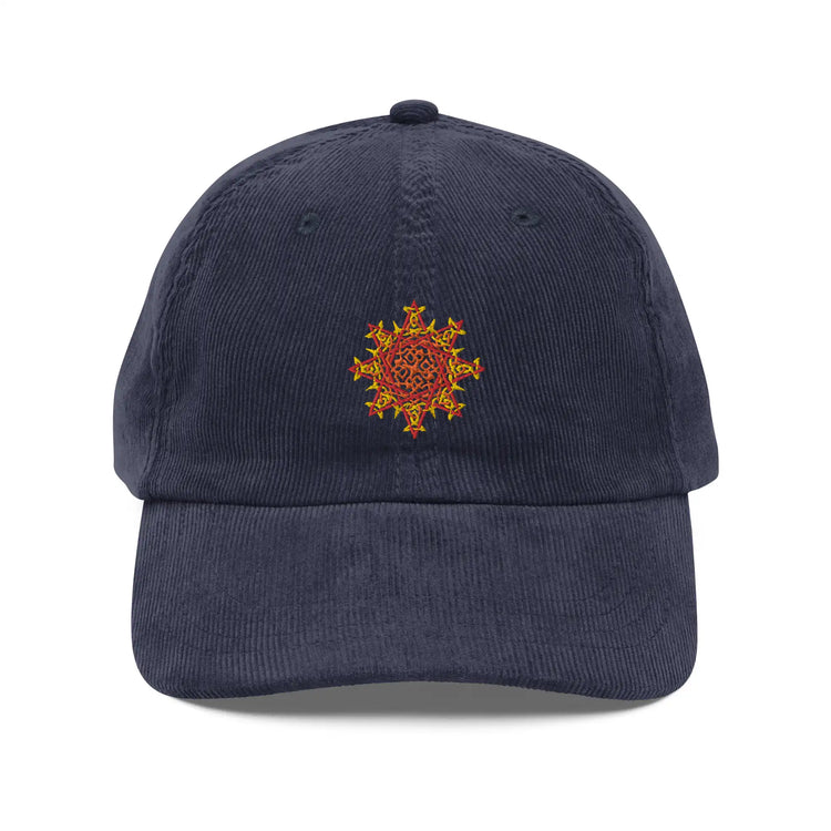 The front side of a navy blue Xigfireon vintage corduroy cap embroidered with the Fire Colour iteration of the `Morning Star Fire` Celtic knot design.
