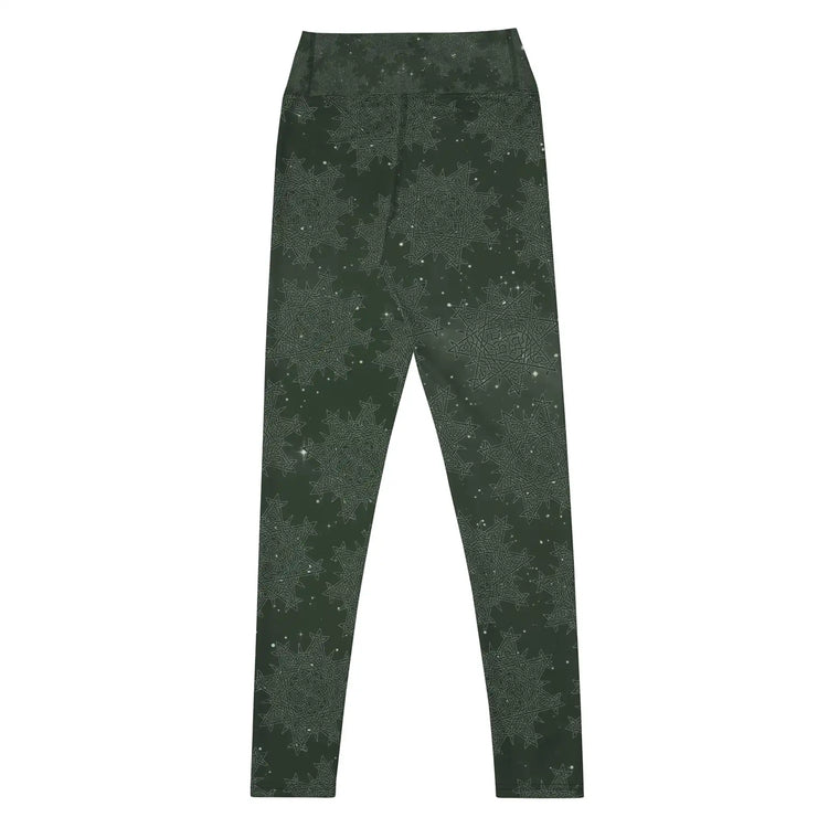 The back side of a pair of Xigfireon graphic yoga leggings featuring the Midnight Green Cosmos patterned series of the `Morning Star Fire` Celtic knot design.