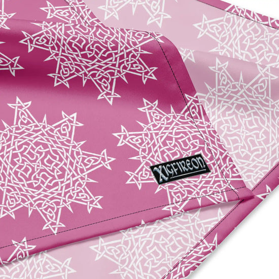 A close up view of the Xigfireon logo on a large sized (25.25 inch x 25.25 inch) `Morning Star Fire` Pink and White bandana.