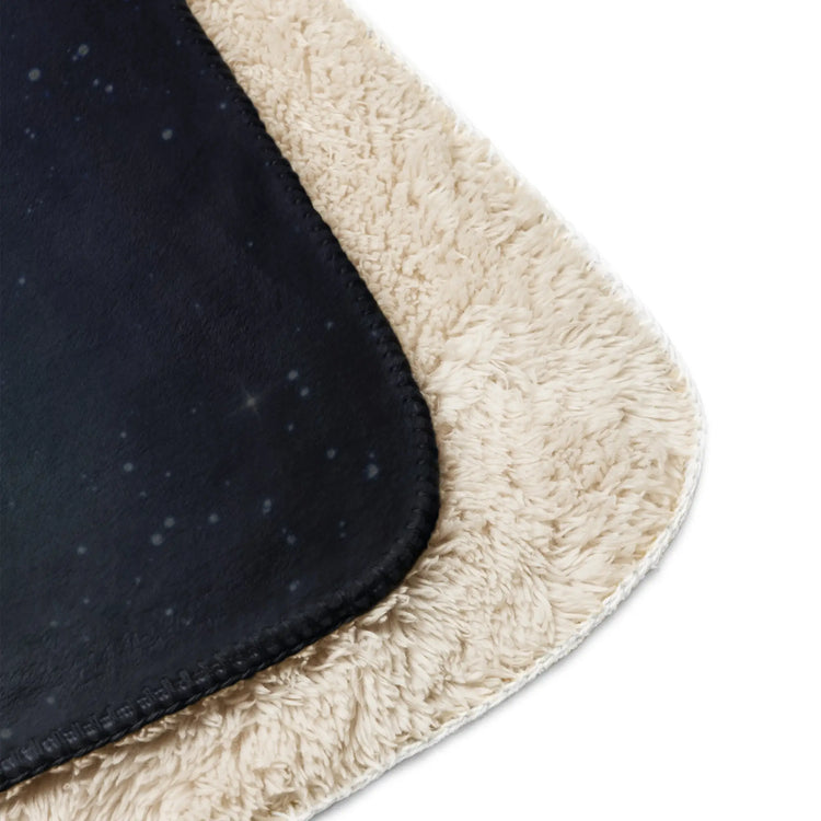 A close-up of the corners of a 37 inch by 57 inch Xigfireon sublimated sherpa blanket featuring the Eclipsed iteration of the `Morning Star Fire` Celtic knot design. Inspired by the 2023 Annular Solar Eclipse.