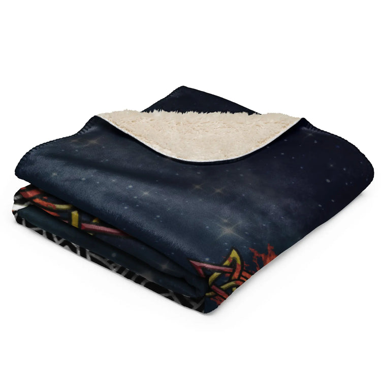 A folded 37 inch by 57 inch Xigfireon sublimated sherpa blanket featuring the Eclipsed iteration of the `Morning Star Fire` Celtic knot design. Inspired by the 2023 Annular Solar Eclipse.