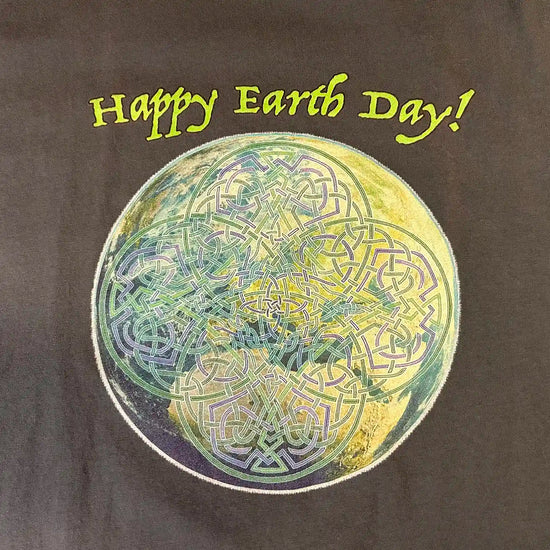 A close-up of a stargazer organic graphic t-shirt featuring the Sacred Planet iteration of the `Reach Of The Spirit` Celtic knot design under a message reading "Happy Earth Day".