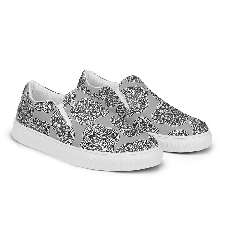 The right side of a pair of Xigfireon canvas slip-ons featuring the Inverted Black & White Solid iteration of the `Reach of The Spirit` Celtic knot pattern.