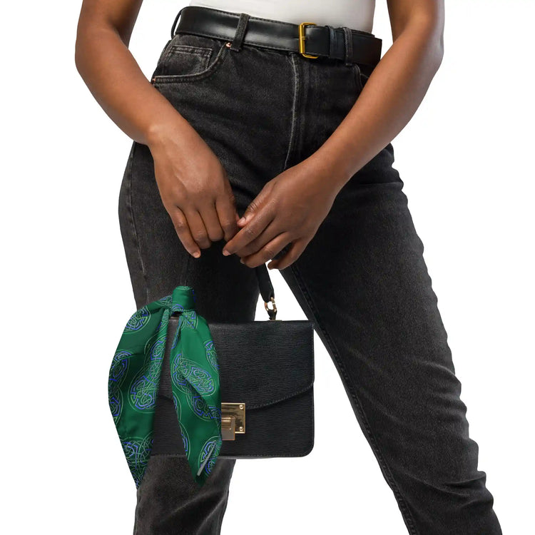 A young woman shown carrying a small purse with a Xigfireon `Reach Of The Spirit` Living Colour Forest bandana tied to one of its straps.