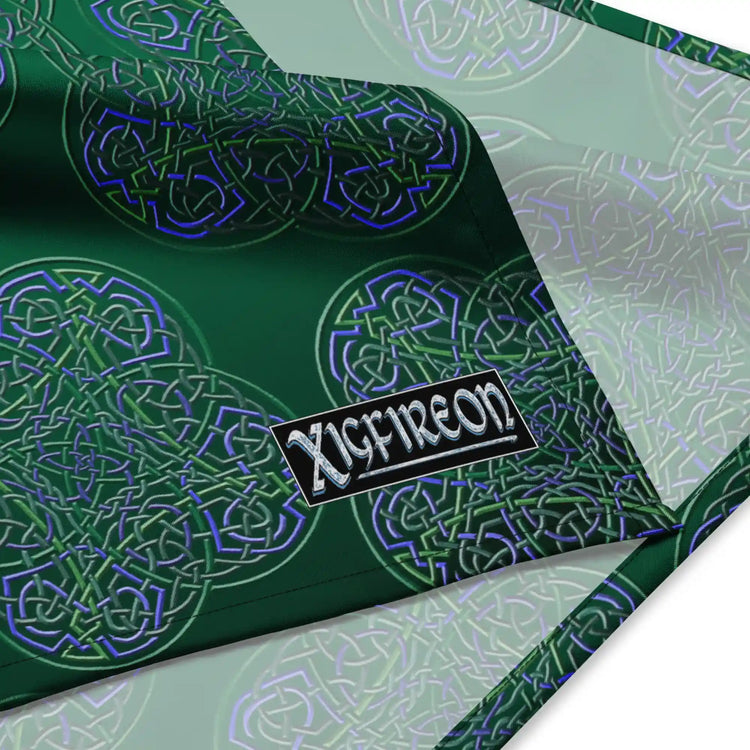 A close up view of the Xigfireon logo on a small sized (17.37 inch x 17.37 inch) `Reach Of The Spirit` Living Colour forest bandana.