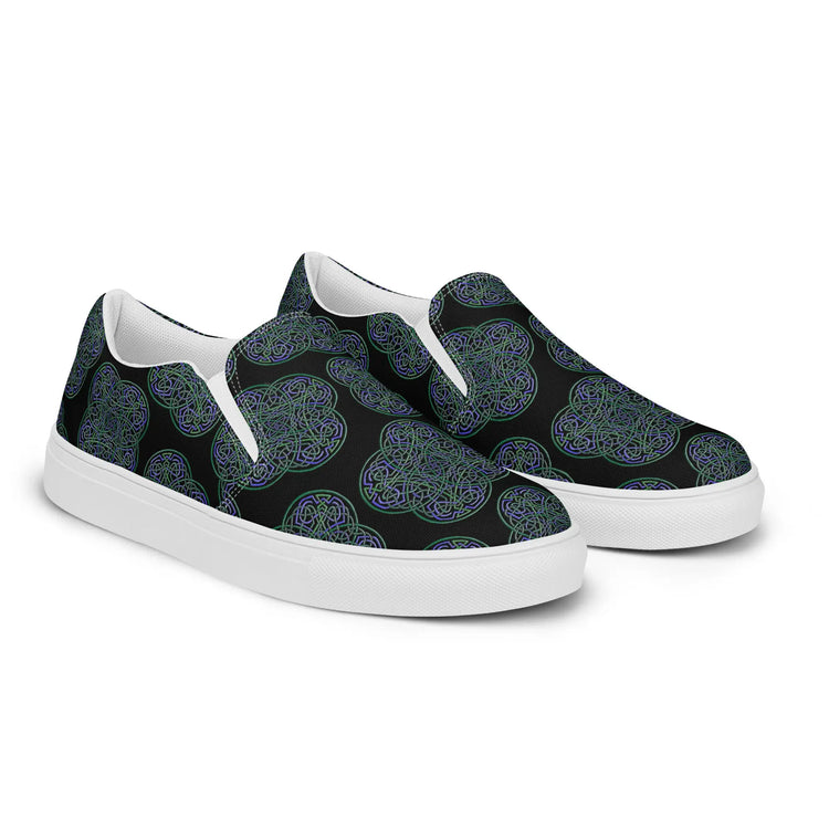 A pair of Xigfireon canvas slip-on shoes featuring the Living Colour on Black iteration of the `Reach Of The Spirit` Celtic knot pattern. The `Reach Of The Spirit` Celtic knot represents the Earth.