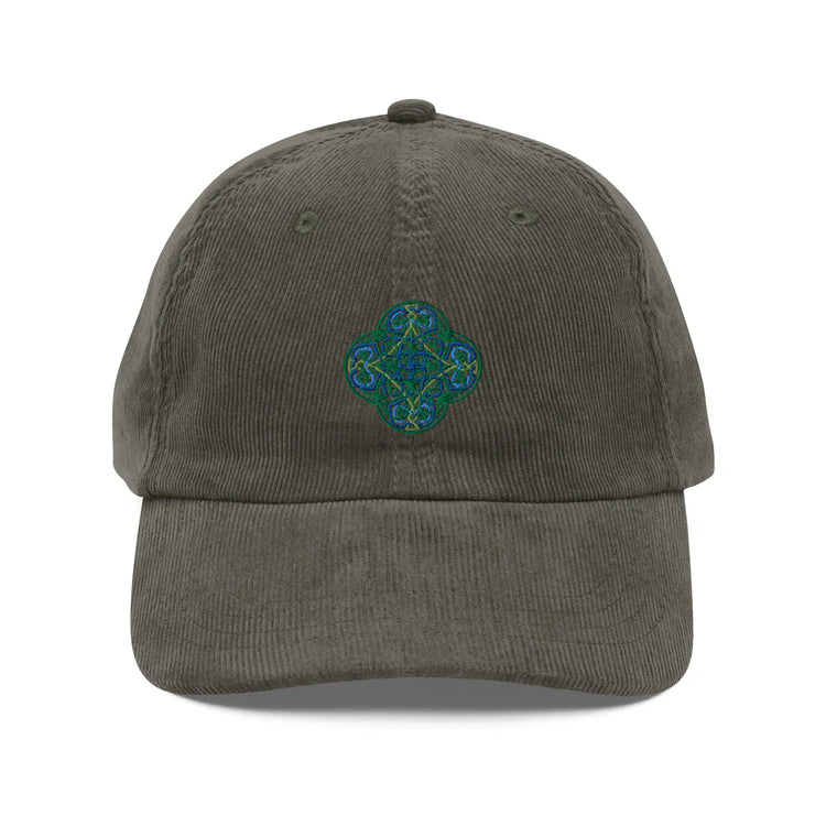 The front side of an olive green Xigfireon vintage corduroy cap embroidered with the Living Colour iteration of the `Reach Of The Spirit` Celtic knot design.