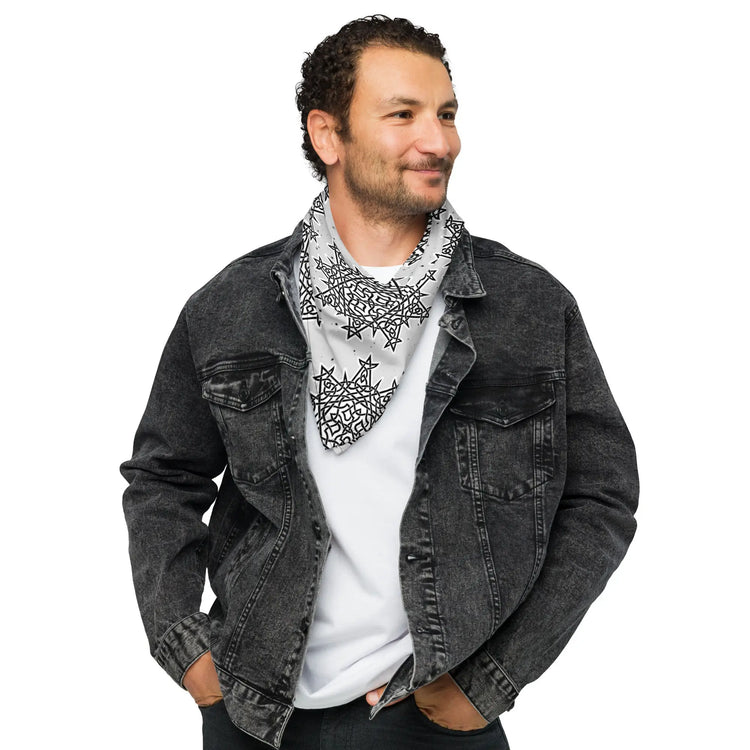 A young man wearing a Xigfireon bandana adorned with the Morning Star Fire Black and White Solid Cosmos Inverted Celtic knot pattern.