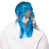 A young woman shown wearing a Xigfireon bandana adorned with the Morning Star Fire Black and White Solid Cosmos Inverted Celtic knot pattern.