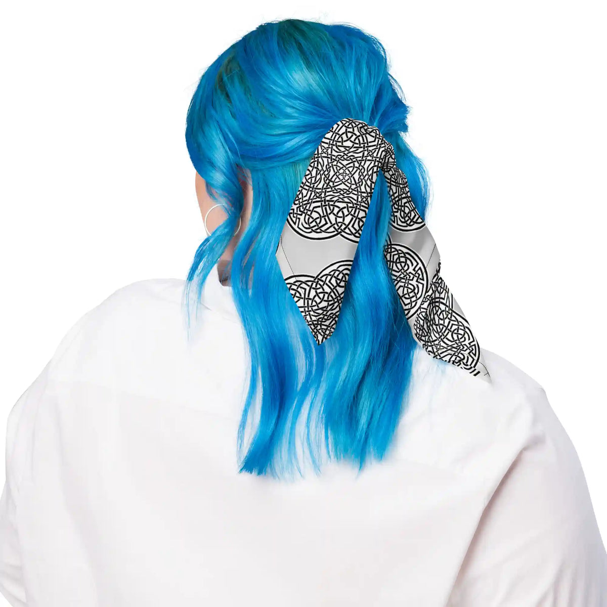 A young woman with blue hair shown wearing a Xigfireon bandana adorned with the Reach Of The Spirit Black and White Solid Forest Inverted Celtic knot pattern.