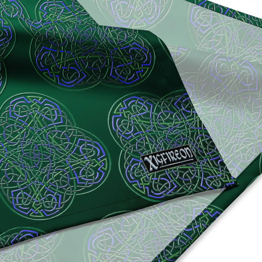 A close up view of the Xigfireon logo on a large sized (25.25 inch x 25.25 inch) Reach Of The Spirit Living Colour Forest bandana.