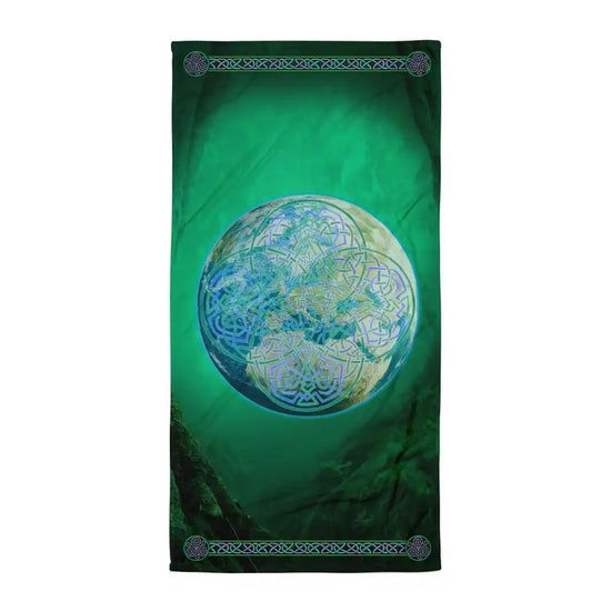 A Xigfireon bath and beach towel featuring the Deep Forest iteration of the Reach Of The Spirit Celtic knot design displayed within a lush green woodland landscape.