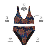 A list of product features surrounding a Xigfireon graphic bikini featuring the Fire Colour Cosmos patterned series of the Morning Star Fire Celtic knot design. Features include recycled polyester and spandex blend fabric, tear away care label, removable paddings, double-layer, and UPF 50+.