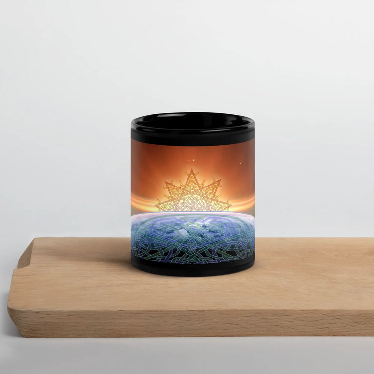 A cutting board underneath an 11oz Xigfireon black glossy graphic mug featuring the Derivation II Celtic knots merger design.