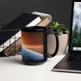 An office desk displaying a 15oz Xigfireon black glossy graphic mug featuring the Derivation II Celtic knots merger design.