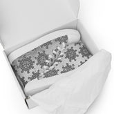 A shoebox containing a pair of canvas high tops featuring the Inverted Black & White Solid Cosmos iteration of the Morning Star Fire Celtic knot pattern.