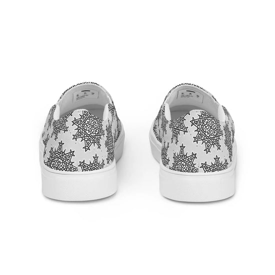 A view of the back of a pair of Xigfireon canvas slip-ons featuring the Inverted Black & White Solid Cosmos iteration of the Morning Star Fire Celtic knot pattern.