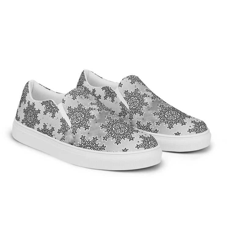 A view of the right side of a pair of Xigfireon canvas slip-ons featuring the Inverted Black & White Solid Cosmos iteration of the Morning Star Fire Celtic knot pattern.