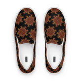 A view from above of a pair of Xigfireon canvas slip-on shoes featuring the Fire Colour on Black iteration of the Morning Star Fire Celtic knot pattern. The Xigfireon logo is visible inside each shoe.