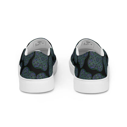 A view of the back of a pair of Xigfireon canvas slip-on shoes featuring the Living Colour on Black iteration of the Reach Of The Spirit Celtic knot pattern. The Reach Of The Spirit Celtic knot represents the Earth.