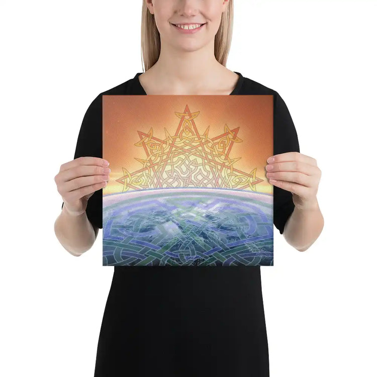 A young woman holding a 12 inch x 12 inch canvas print of the Derivation II Celtic knot design, which symbolizes the Sun and the Earth and their cosmic dance.