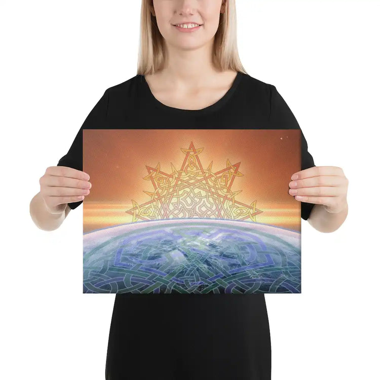 A young woman holding a 12 inch x 16 inch canvas print of the Derivation II Celtic knot design, which symbolizes the Sun and the Earth and their cosmic dance.