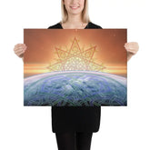 A young woman holding an 18 inch x 24 inch canvas print of the Derivation II Celtic knot design, which symbolizes the Sun and the Earth and their cosmic dance.