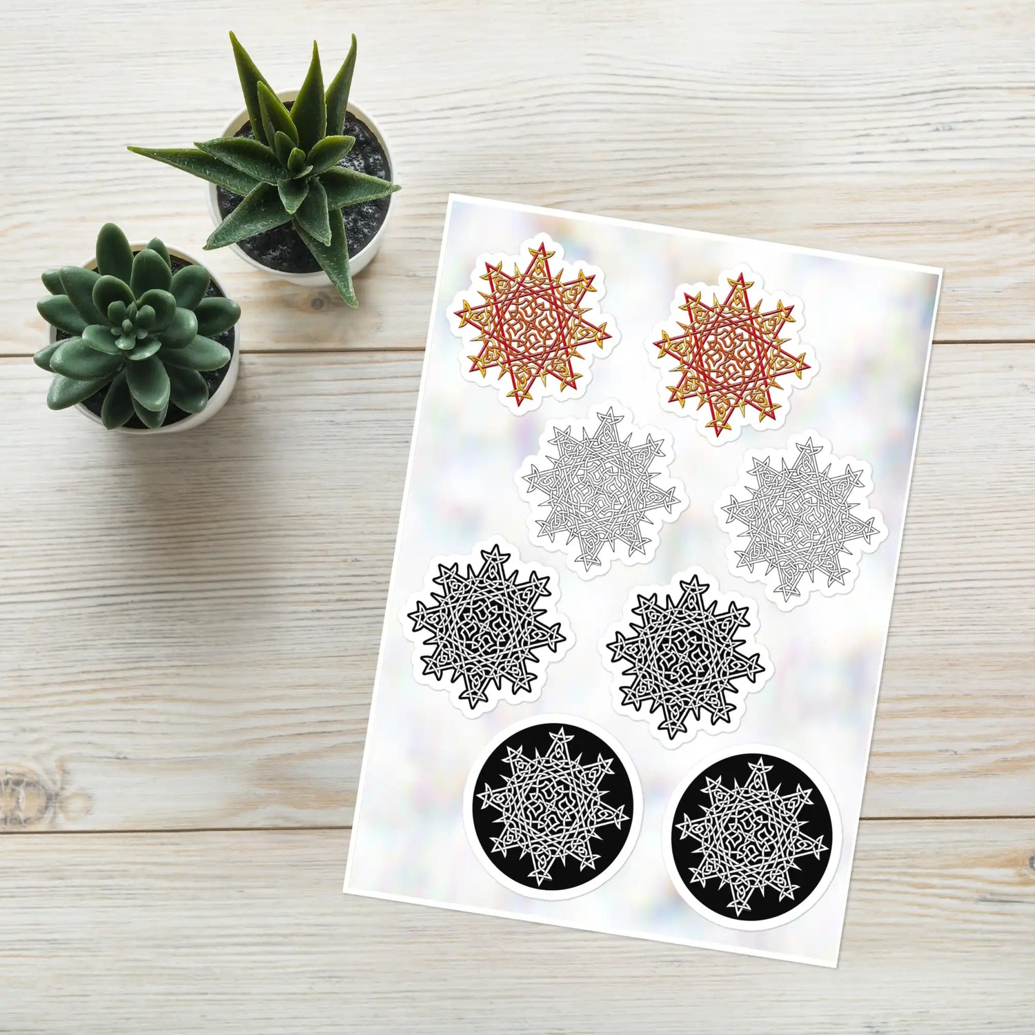 A Xigfireon Celtic knot sticker sheet consisting of 8 individual Morning Star Fire stickers, 2 each of the Fire Colour, Black & White Hollow, Black & White Solid, and Black & White Circle iterations. The Morning Star Fire Celtic knot represents the Sun.