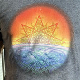 A close up of a gentleman wearing a dark heather Xigfireon graphic t-shirt featuring the Derivation II Celtic knots merger design.